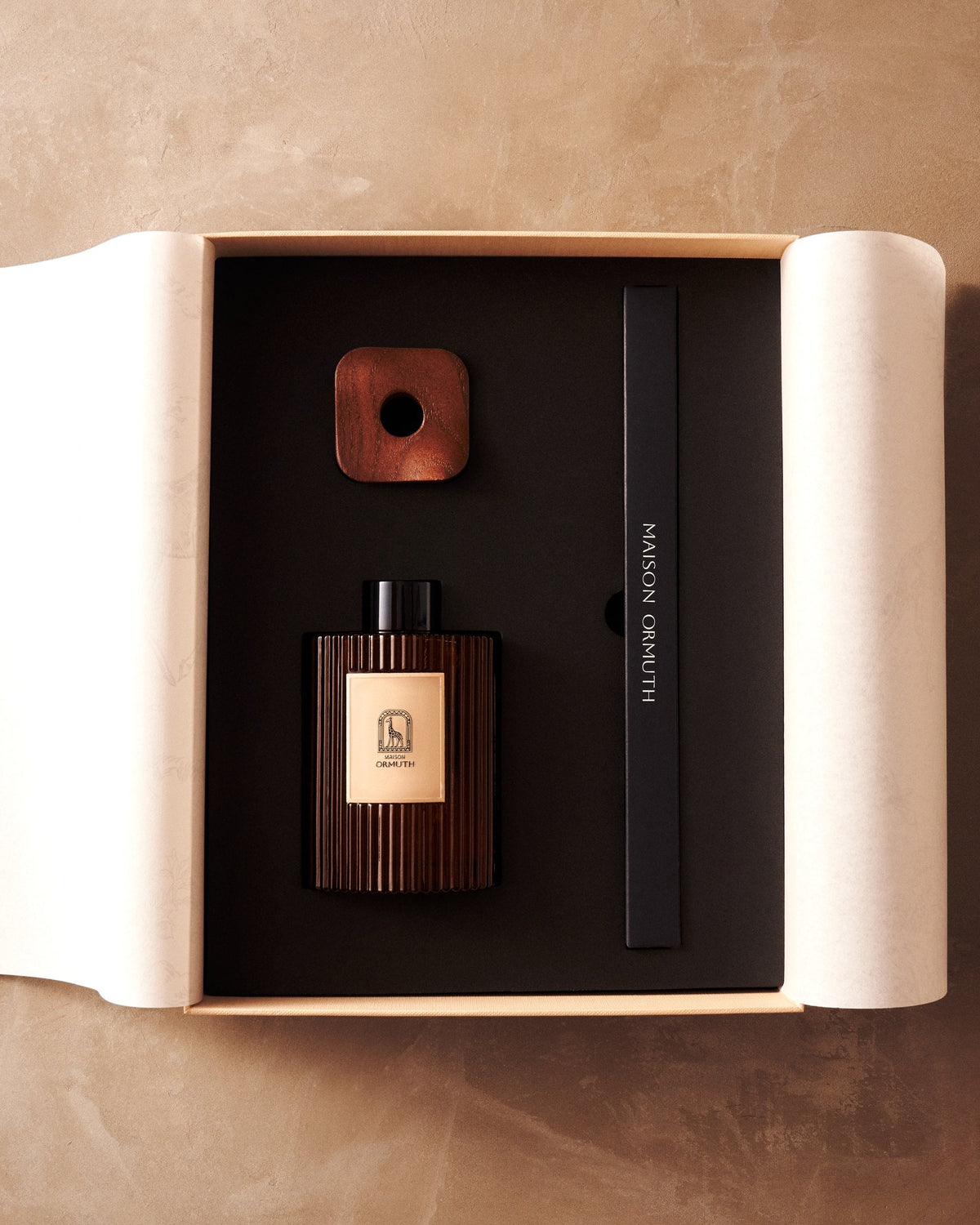 The Maison Ormuth box open, bottle and reed box set in foam