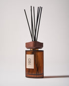Maison Ormuth reed diffuser, turned: ribbed amber glass vessel, wooden cap and black reeds