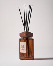 Maison Ormuth reed diffuser, turned: ribbed amber glass vessel, wooden cap and black reeds