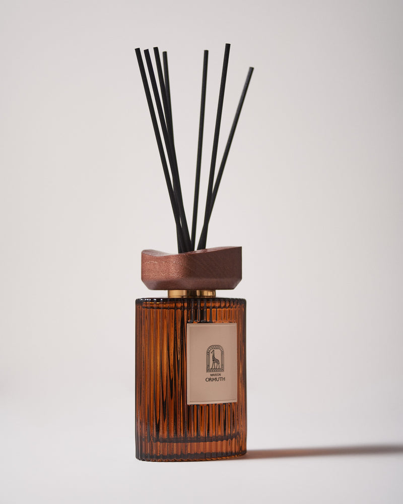 Maison Ormuth reed diffuser: ribbed amber glass vessel, wooden cap and black reeds